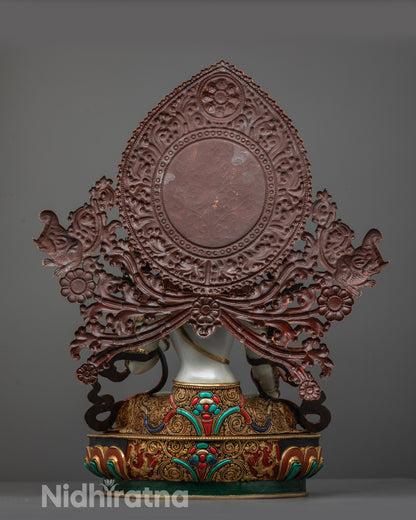 Back view of White Tara Statue showing detailed garments and miniature elephant carving