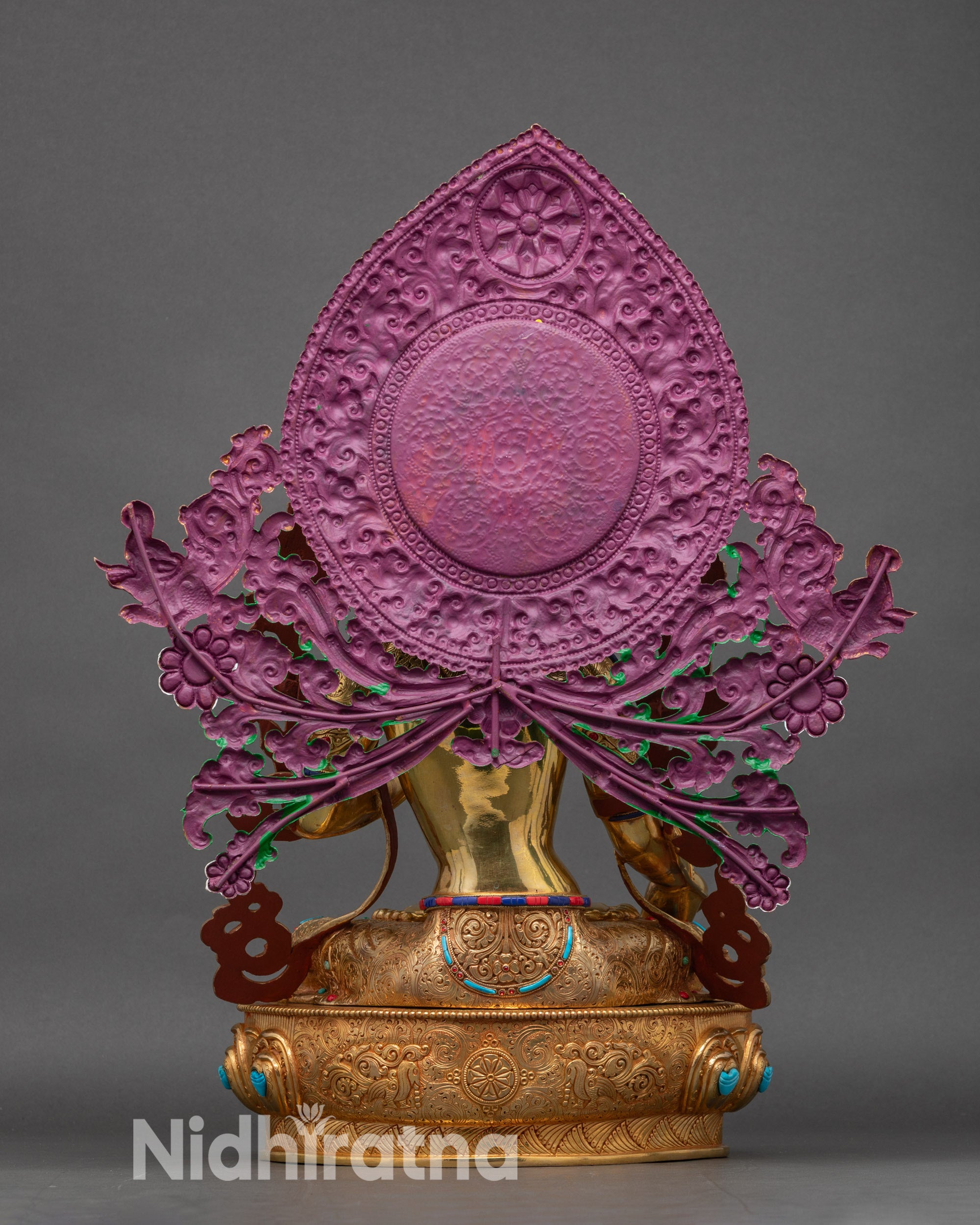 Back view of White Tara sculpture, lotus seat with carved patterns and intricate details