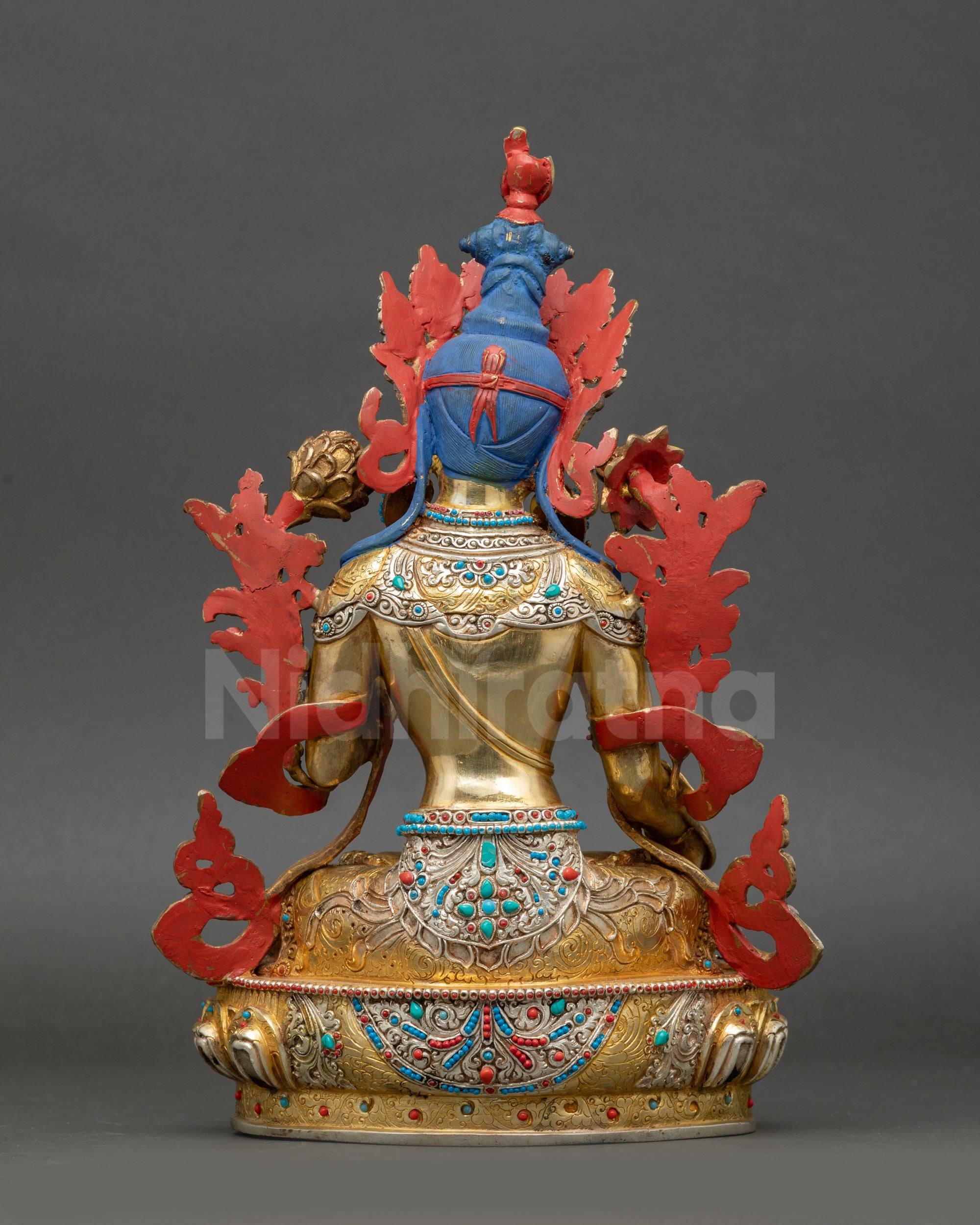 Back view of White Tara statue displaying intricate robe carving and Nepalese craftsmanship