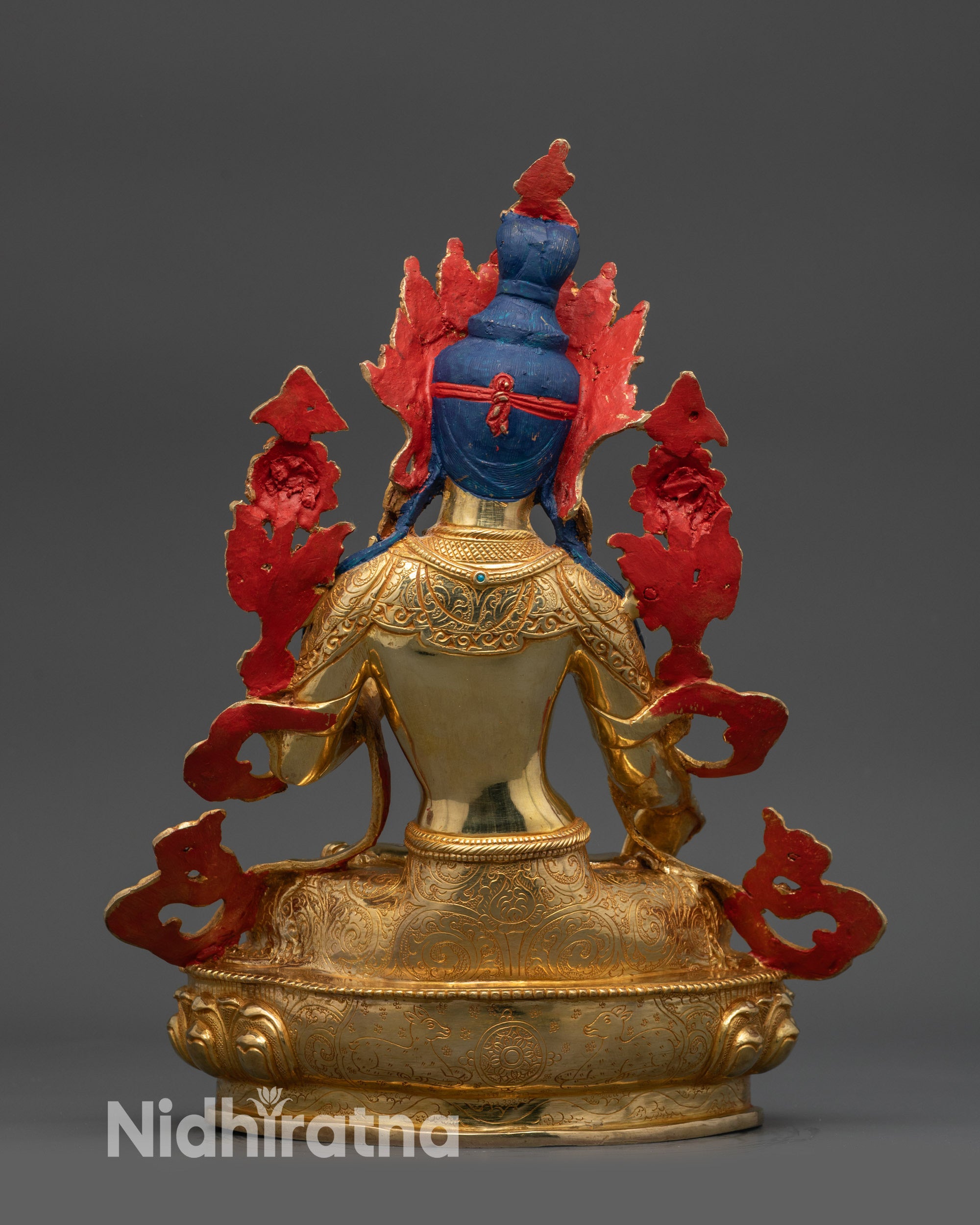 Back view of White Tara statue highlighting carved robe, lotus seat, handcrafted art