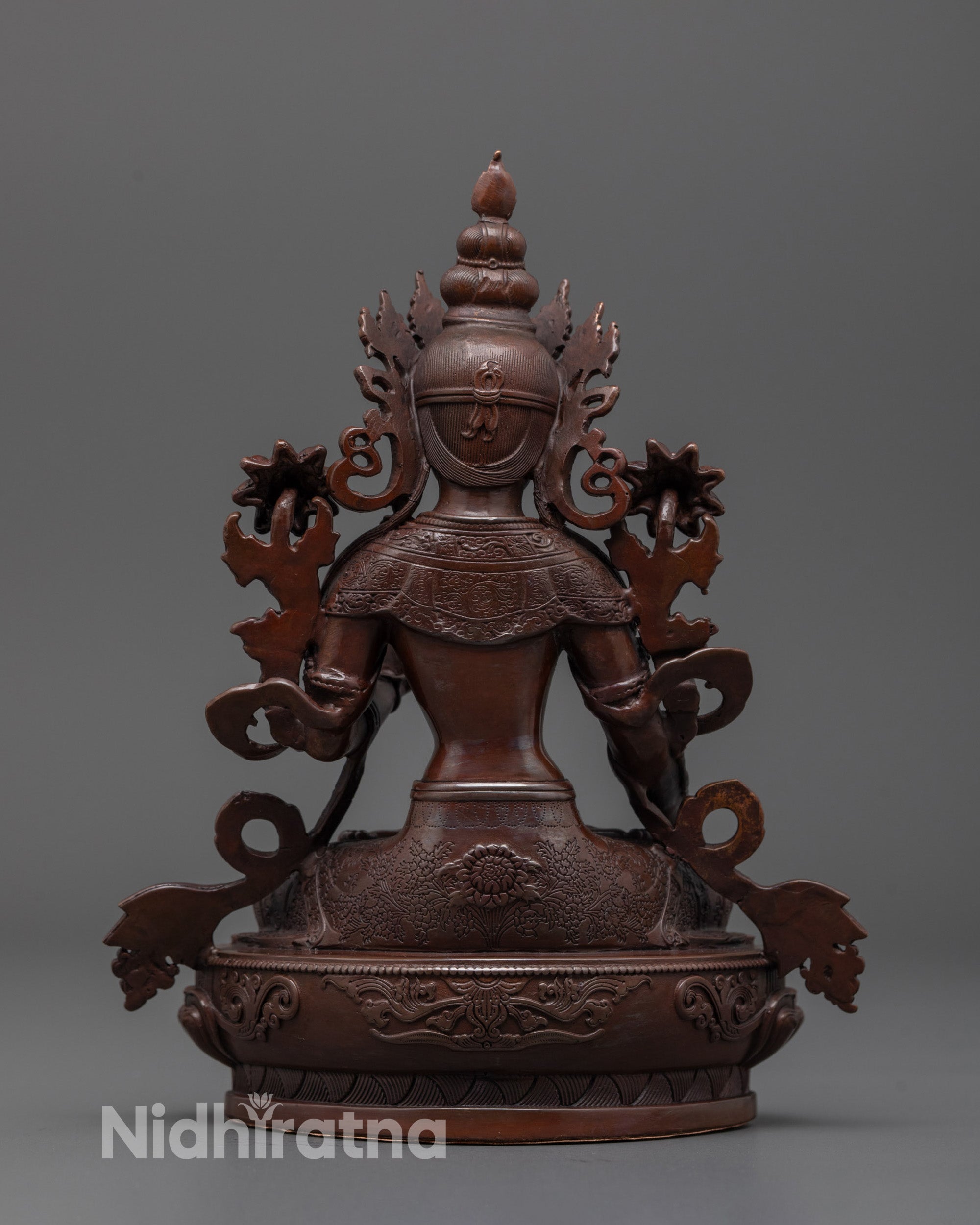 Back view of White Tara statue in oxidized copper, highlighting oxidized finish and design details
