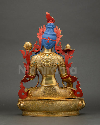 Back view of White Tara statue showing carved patterns on jewelry, robe, and lotus base