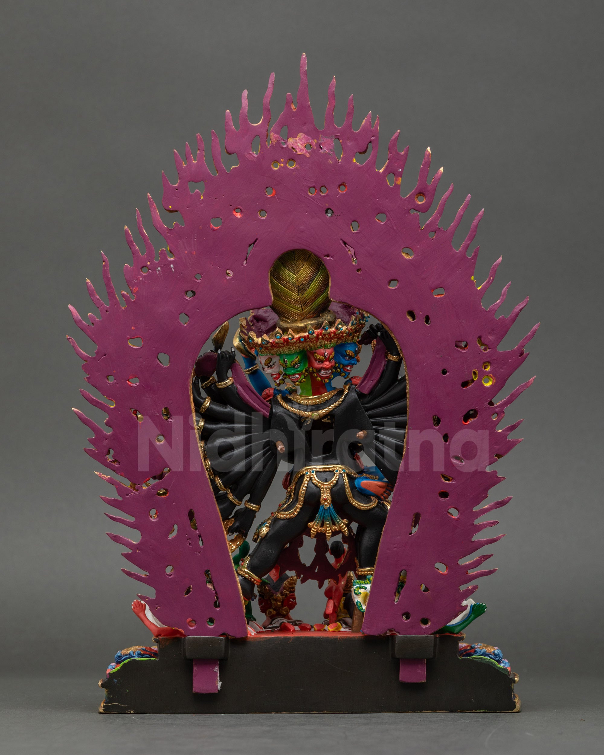 Back view of Yamantaka statue showing detailed carvings and lotus base