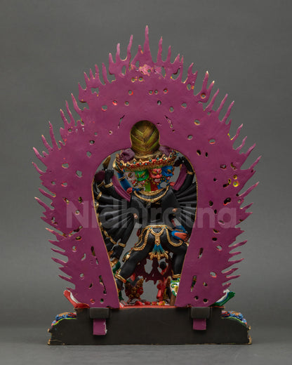 Back view of Yamantaka statue showing detailed carvings and lotus base