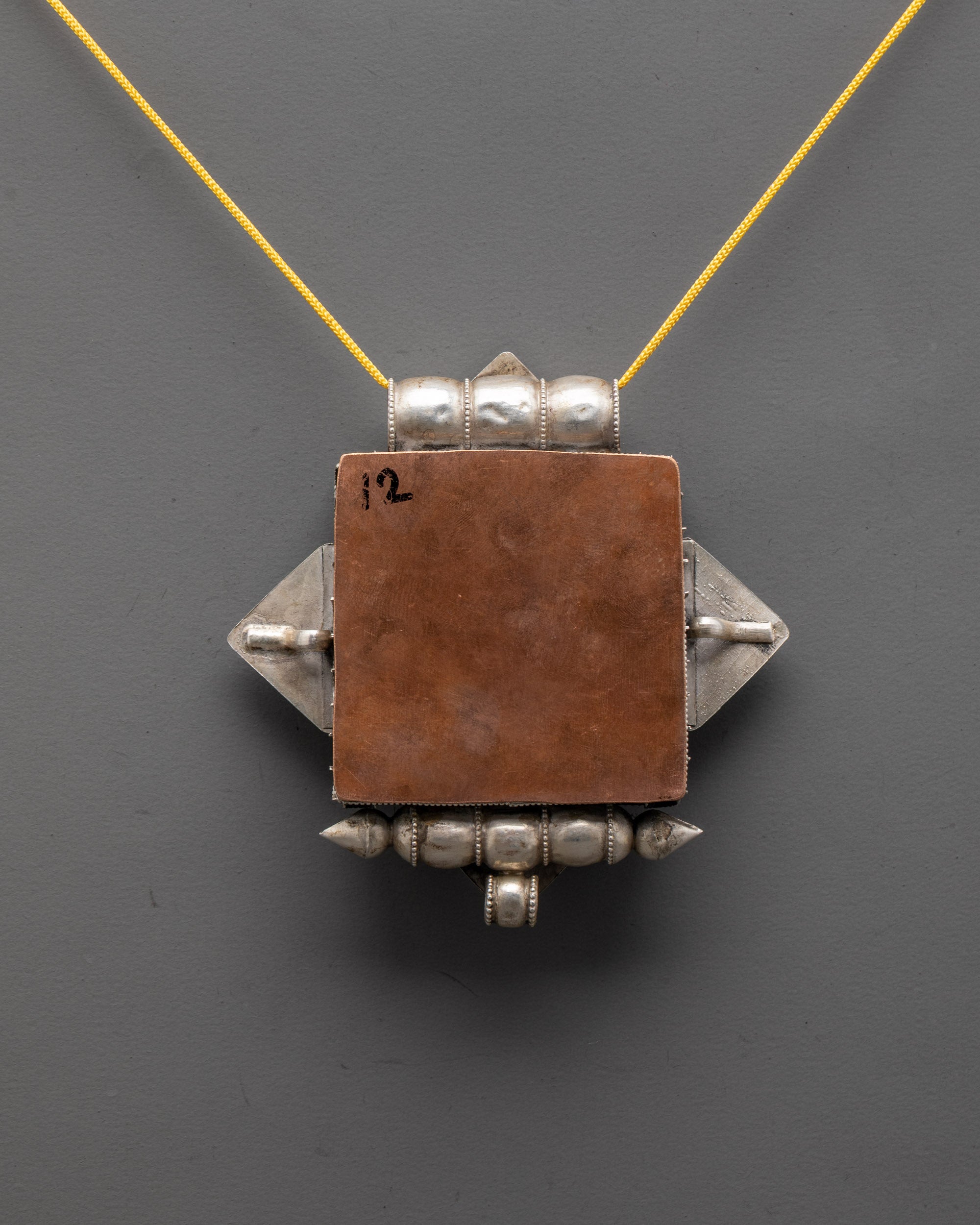 Back view of authentic Himalayan Treasure Vase Locket highlighting craftsmanship and design









Ask ChatGPT
