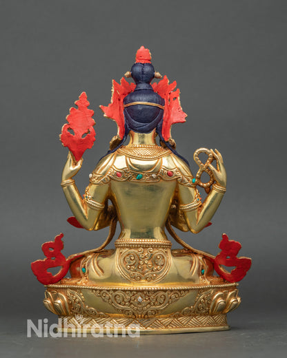 Back view of copper Chenrezig statue with carved robes and fire gilding