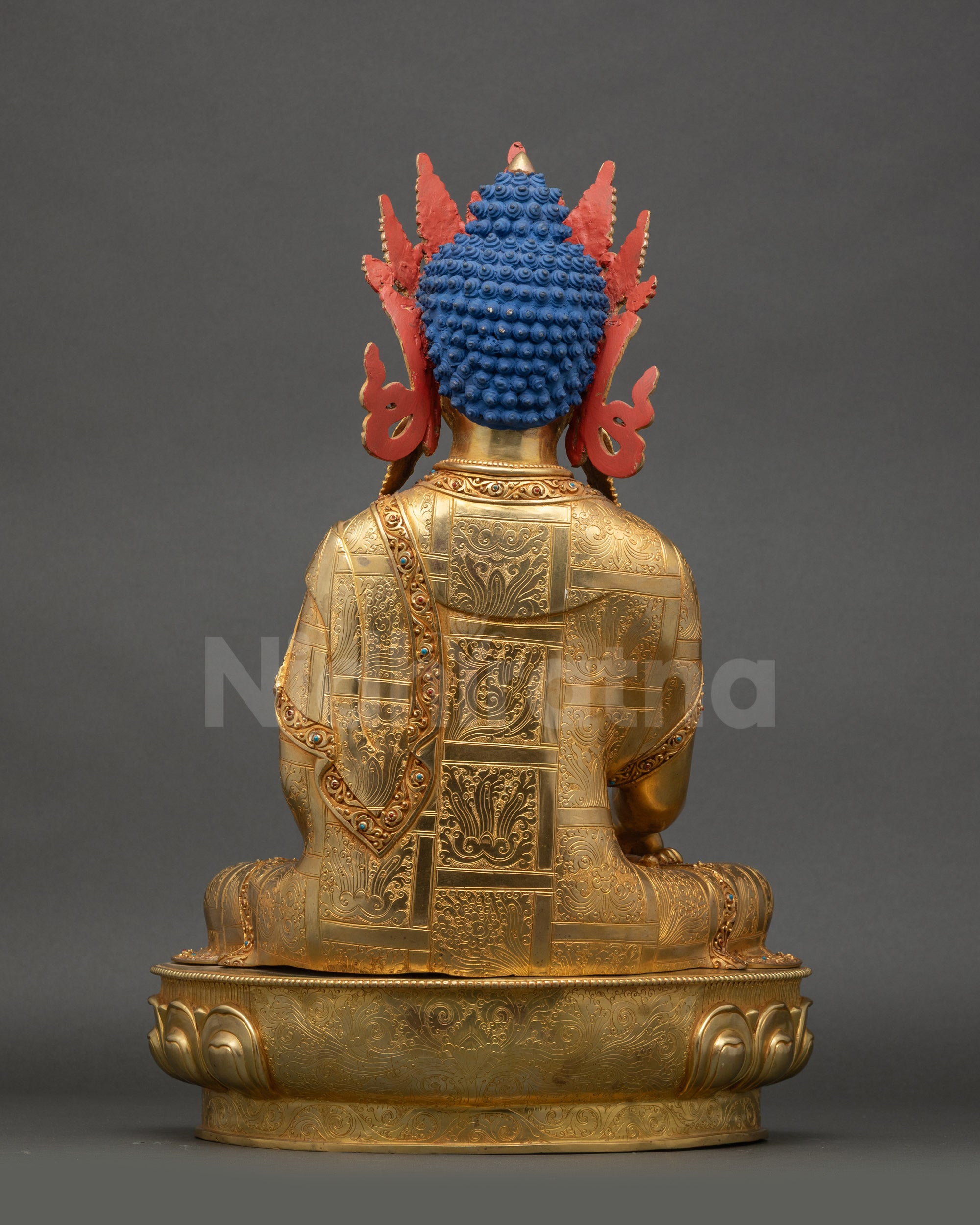 Back view of crowned Shakyamuni Buddha statue with smooth copper surface