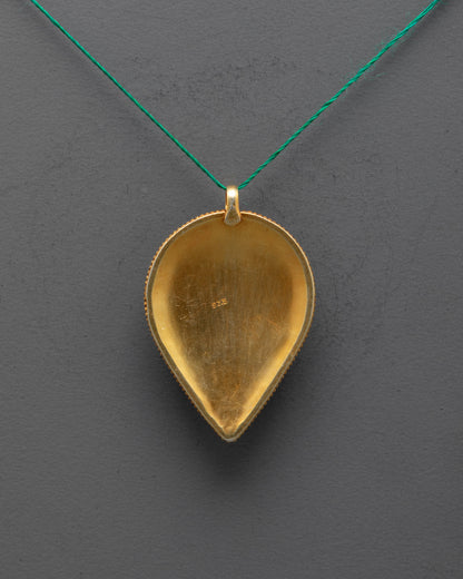 Back view of delicate filigree work on handmade Tibetan leaf-shaped spiritual pendant