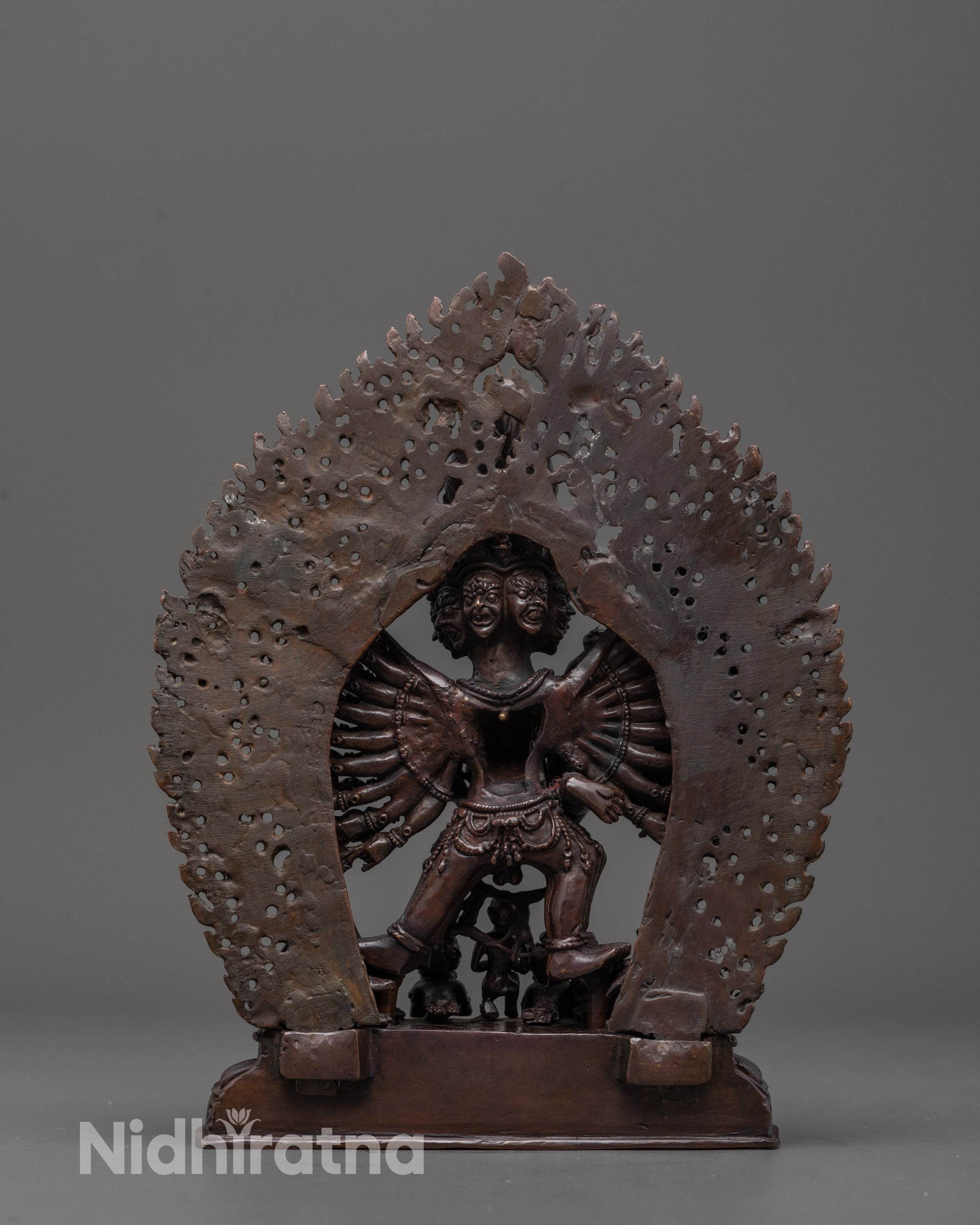 Back view of Yamantaka statue with mini deities and rich oxidized copper texture

