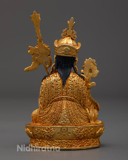 Back view of electroplated Guru Menla statue with intricate robe and throne carvings