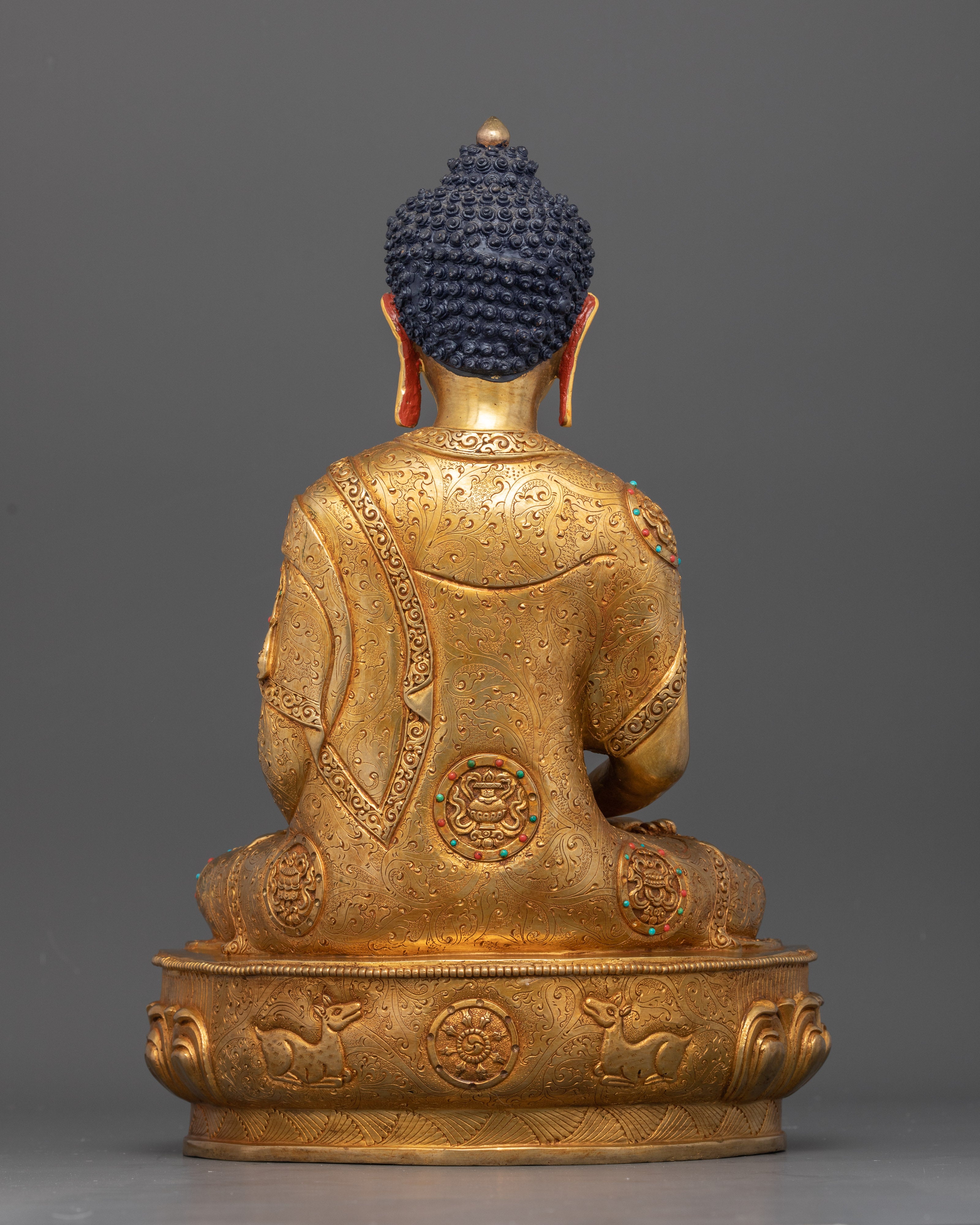 Back view of gold-gilded Amitabha Buddha with detailed lotus pedestal 