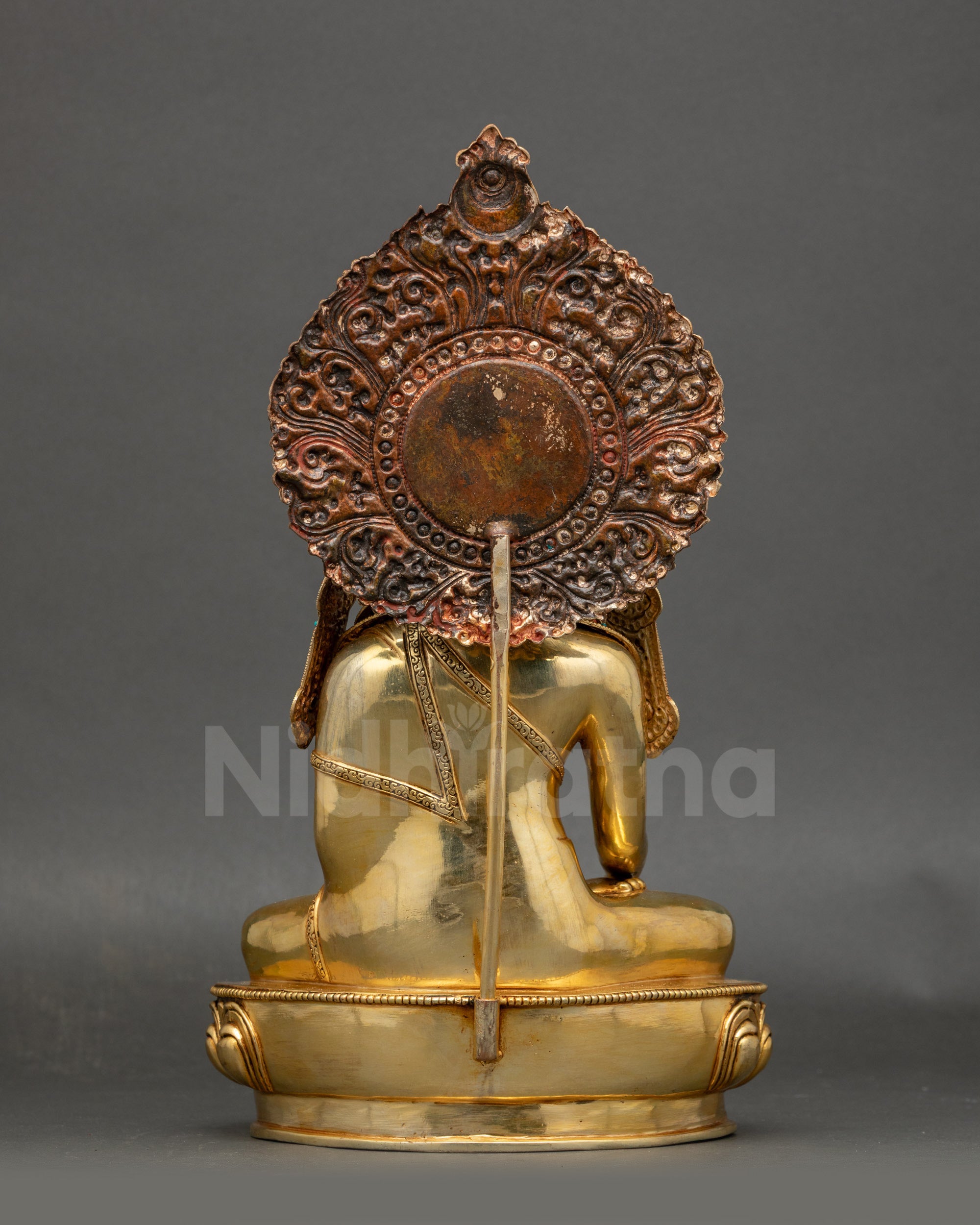 Back view of gold-gilded Jowo Shakyamuni Buddha with carved lotus base and halo