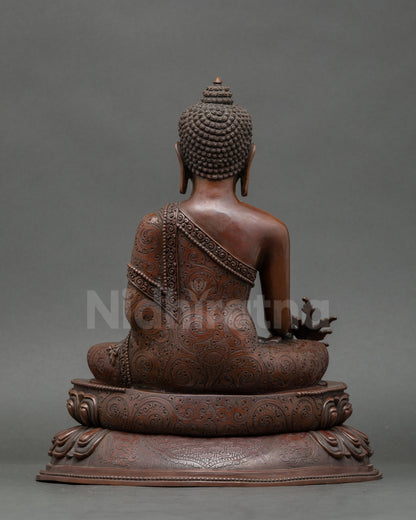 Back view of gold-gilded Medicine Buddha sculpture for meditation and home altar