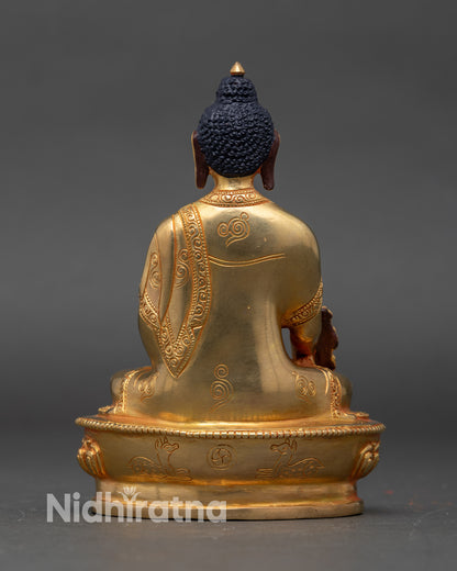 Back view of gold-gilded Medicine Buddha statue with lotus throne and traditional detailing