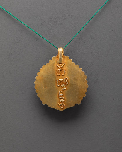 Back view of gold-gilded Mother Tara locket highlighting intricate carving and vibrant semi-precious stones