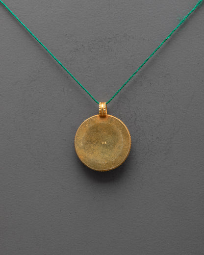 Back view of gold-plated Lotus Locket highlighting artisan carving and smooth finish