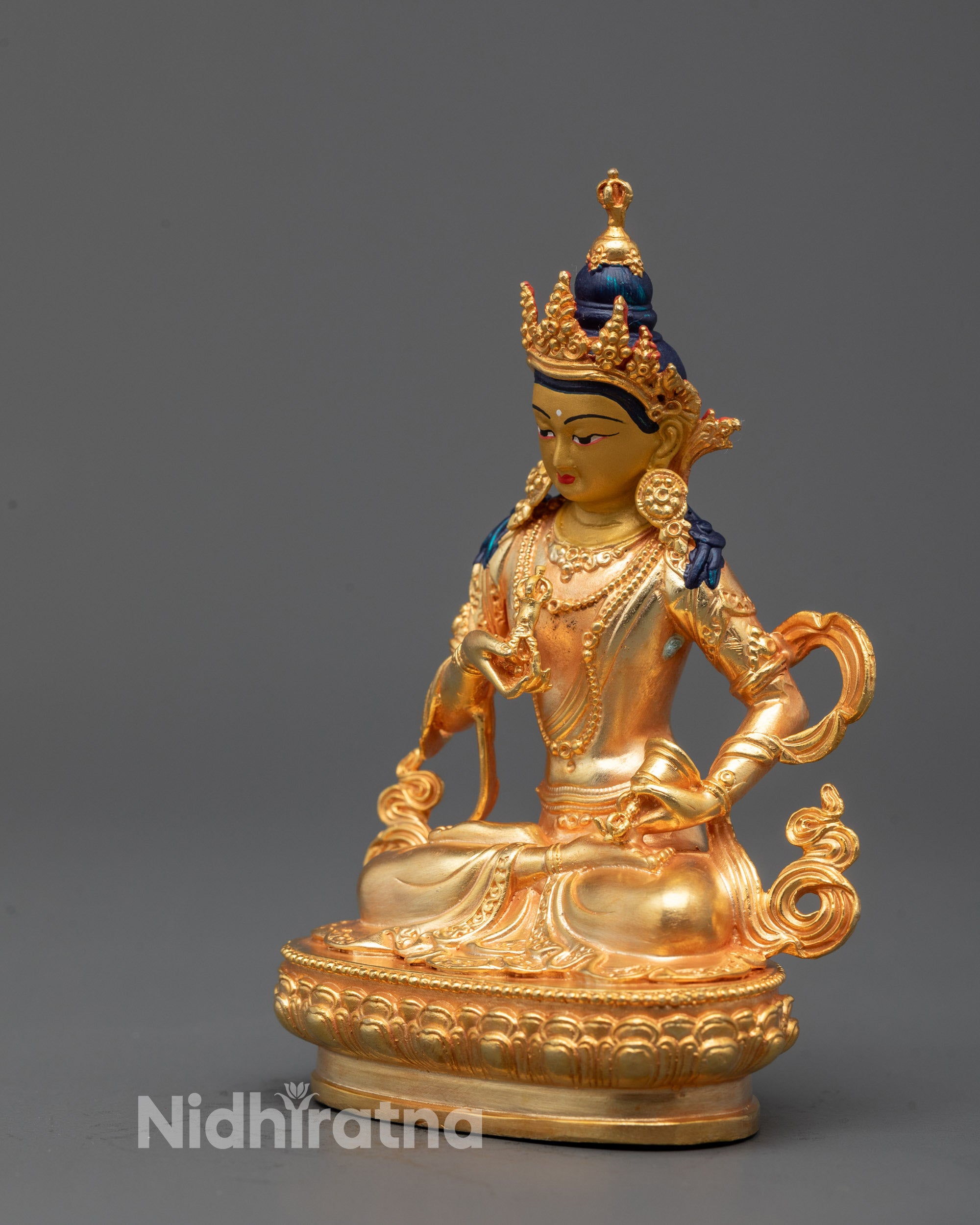 Back view of gold-plated Vajrasattva statue showcasing detailed robe patterns and crown