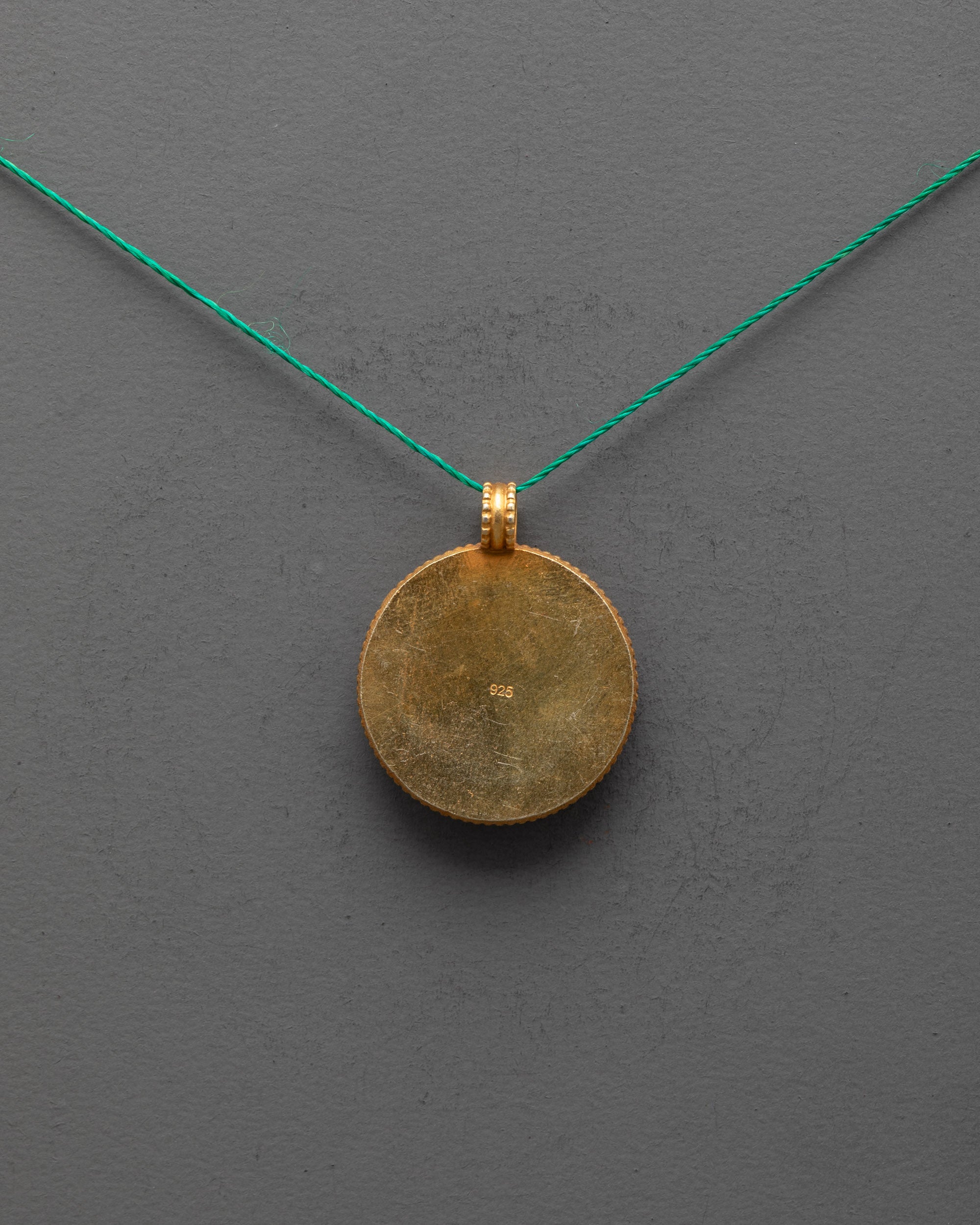 Back view of gold-plated copper golden fish locket, traditional Nepalese artisan craftsmanship