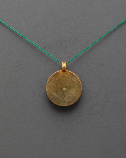 Back view of gold-plated copper golden fish locket, traditional Nepalese artisan craftsmanship