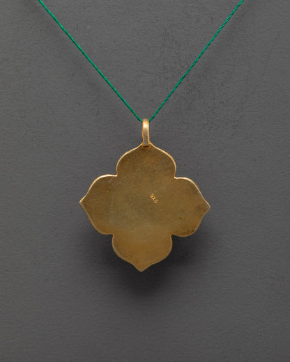Back view of gold-plated lotus locket revealing intricate filigree and artisan craftsmanship