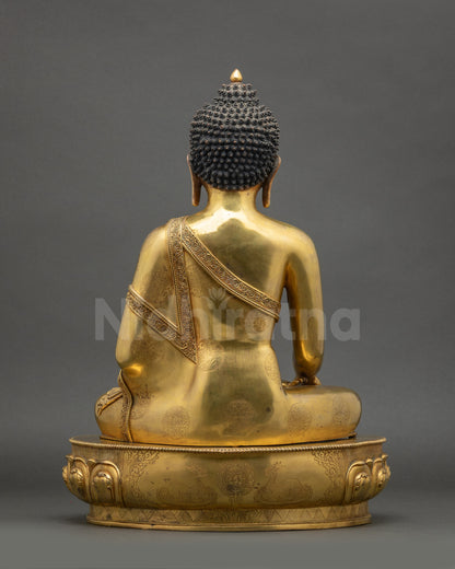 Back view of gold fire-gilded Shakyamuni Buddha statue from Nepal showing lotus seat and robe carvings
