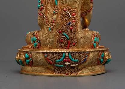 Back view of gold fire-gilded Shakyamuni statue highlighting intricate robe carvings