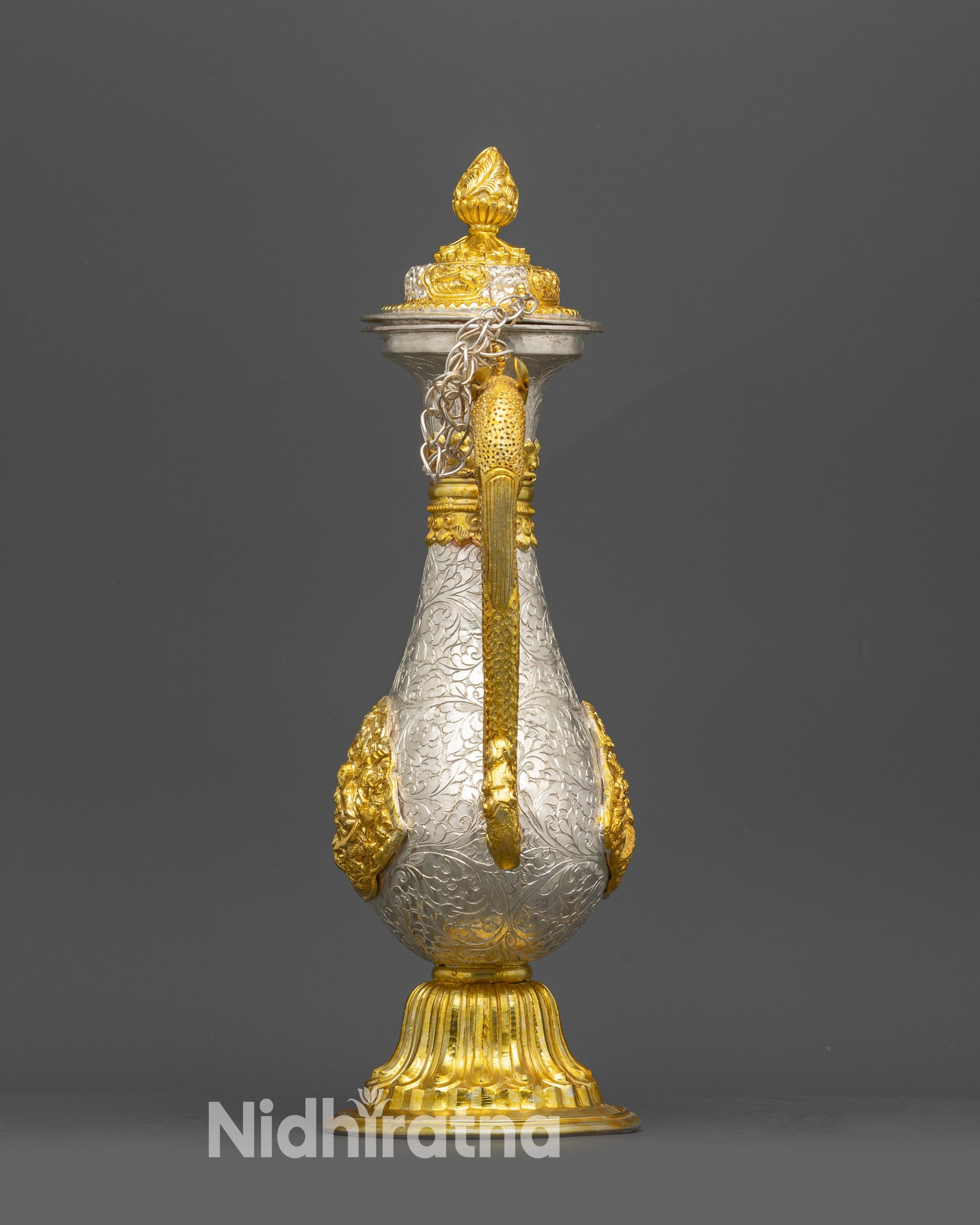 Back view of gold & silver-plated Tea pot resting on smooth pedestal
