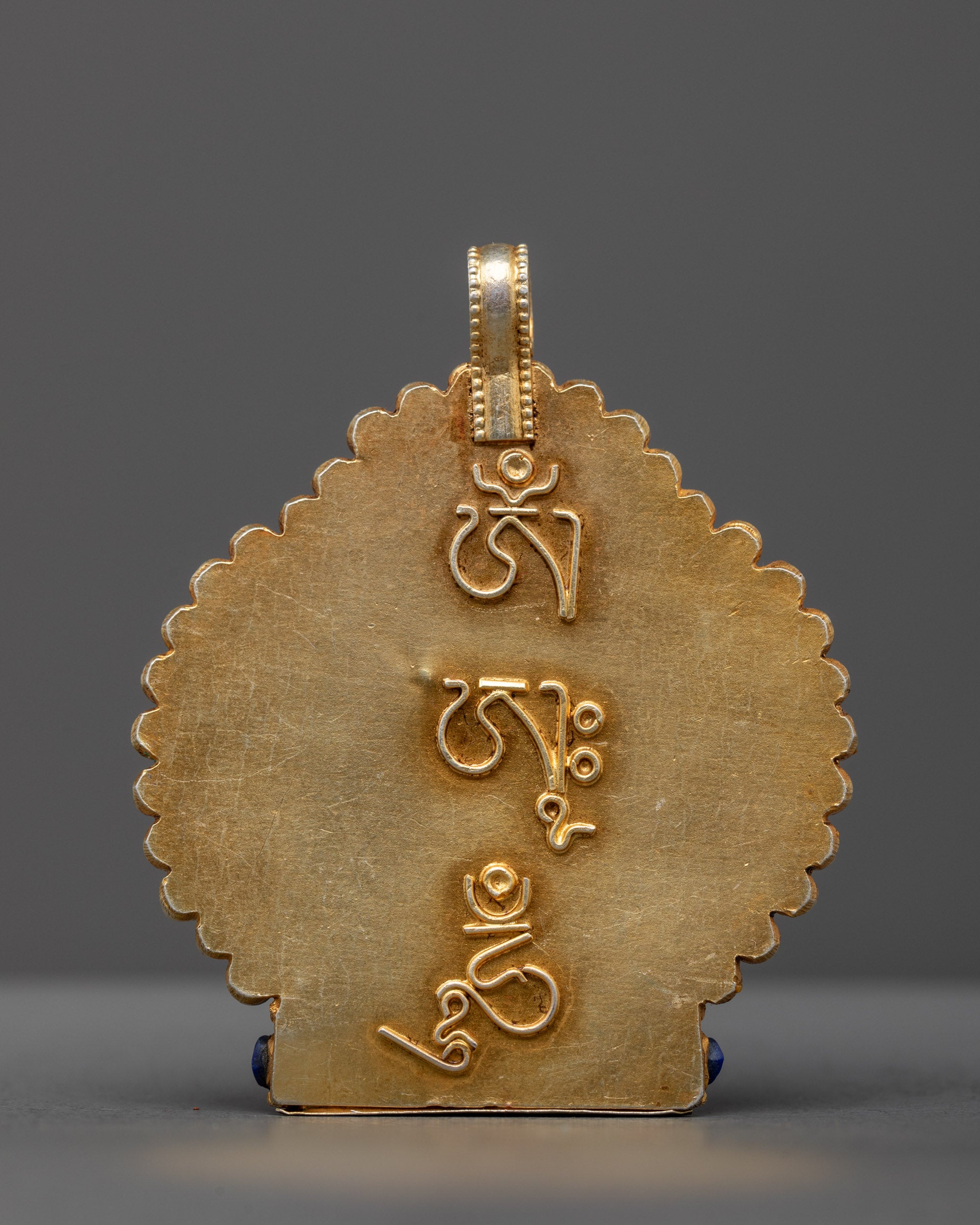 Back view of handcrafted Chenrezig Locket featuring detailed gold-gilded carvings—sacred Buddhist talisman from Patan, Nepal.