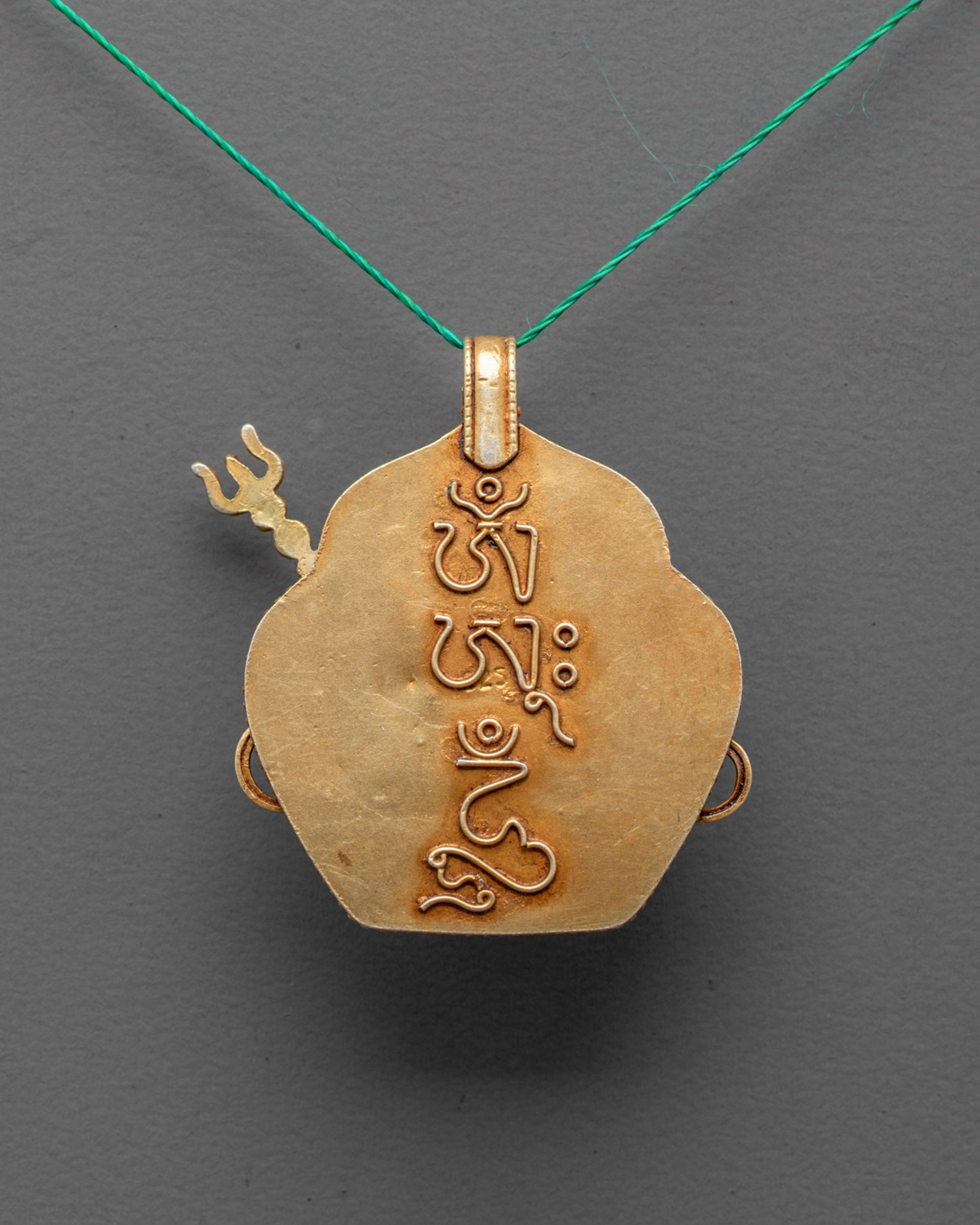 Back view of handcrafted Guru Rinpoche Pendant with intricate filigree detail
