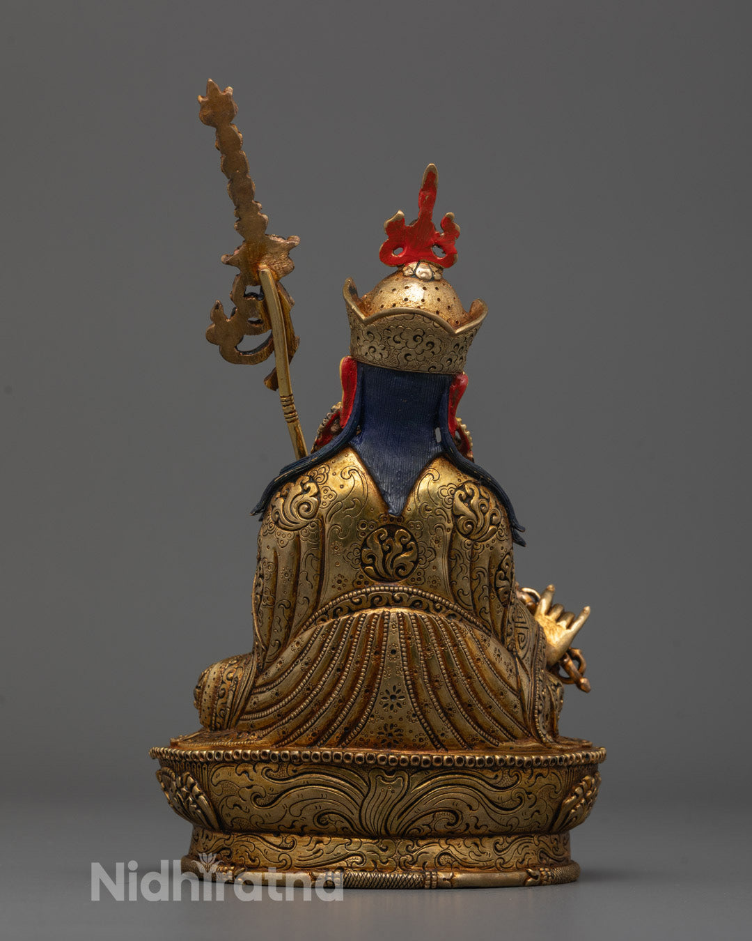 Back view of handcrafted Guru Rinpoche statue showing detailed lotus hat and flowing robe design