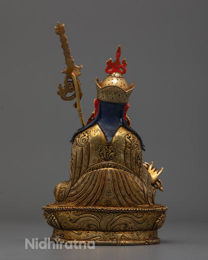 Back view of handcrafted Guru Rinpoche statue showing detailed lotus hat and flowing robe design