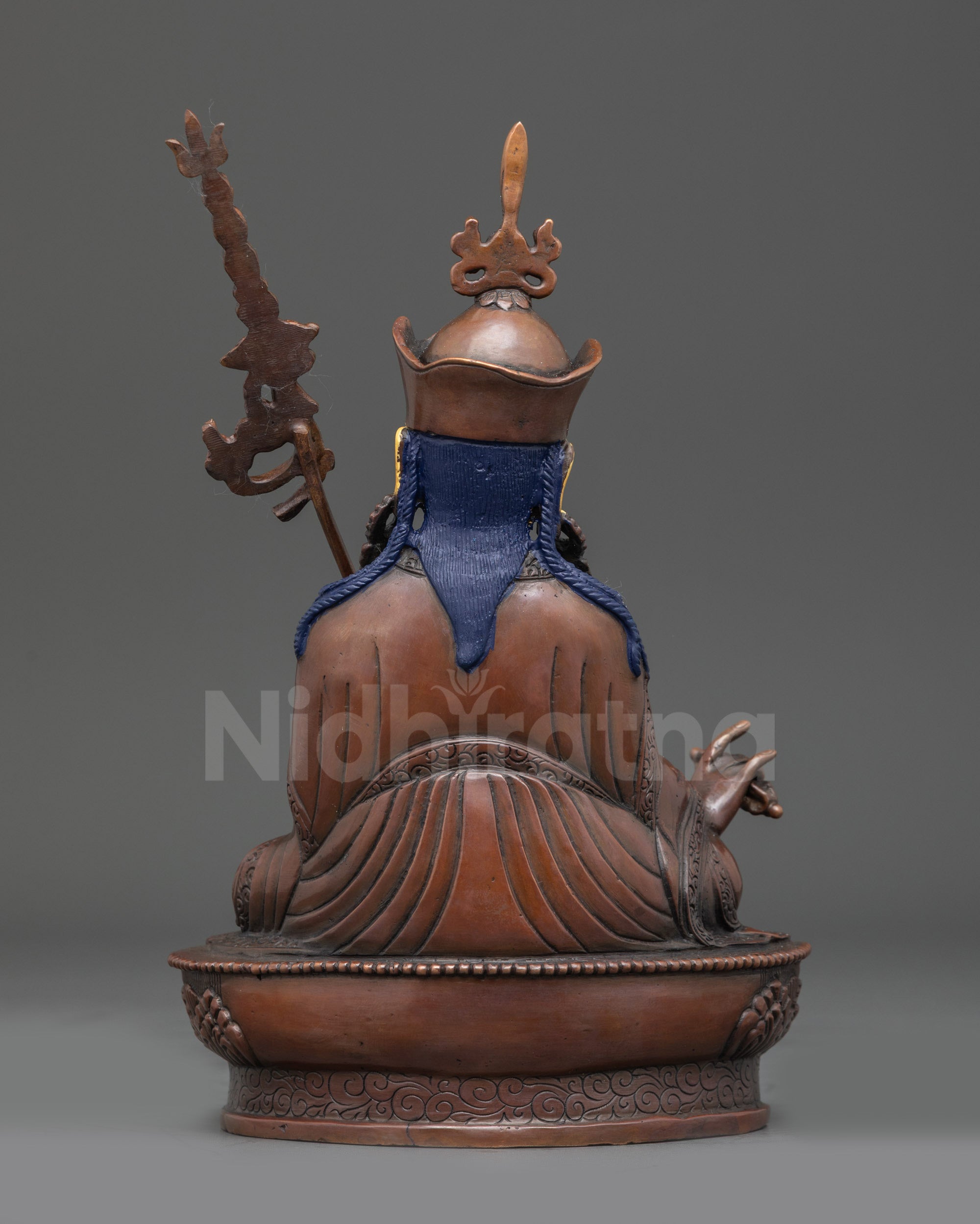 Back view of handcrafted Guru Rinpoche statue showing flowing robes and scarf