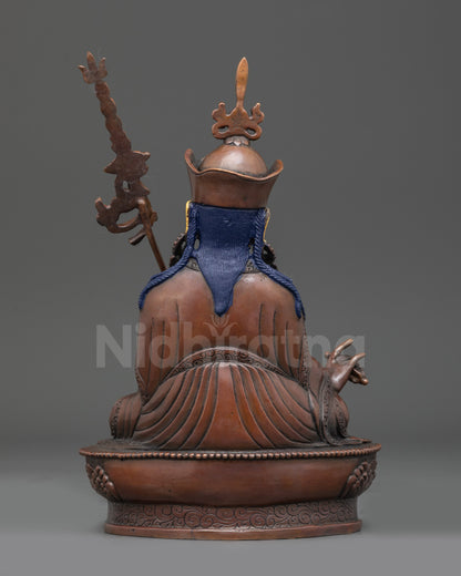 Back view of handcrafted Guru Rinpoche statue showing flowing robes and scarf