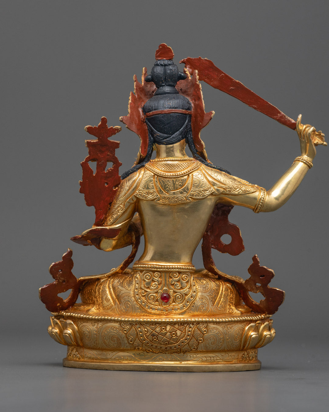 Back view of handcrafted Manjushri Bodhisattva statue highlighting ornate carvings