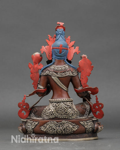 Back view of handcrafted Nepalese Green Tara statue on traditional lotus pedestal