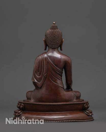 Back view of handcrafted Tibetan Buddha statue showing detailed lotus base