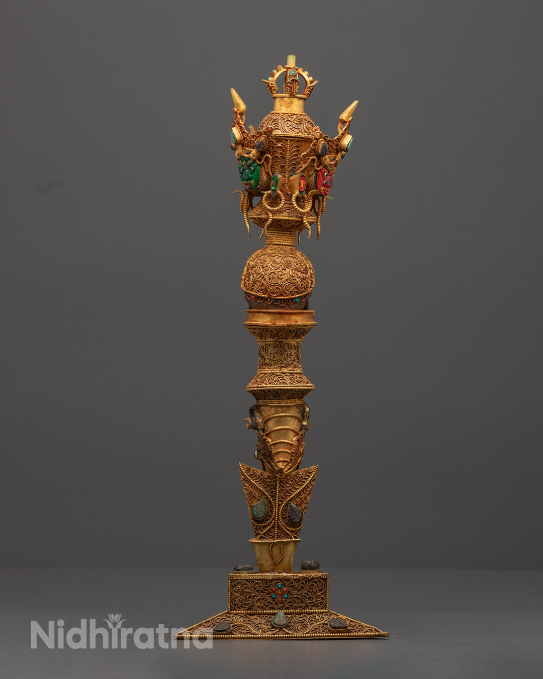 Back view of handcrafted copper Phurba highlighting intricate craftsmanship and stones