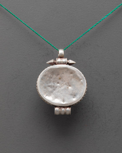 Back view of handcrafted silver locket pendant with detailed Tibetan craftsmanship
