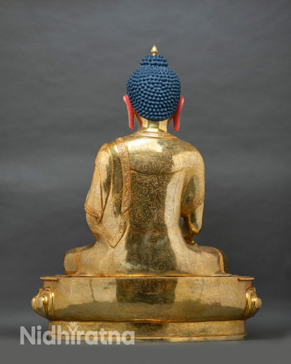 Back view of large copper Shakyamuni Buddha statue with gold fire-gilded robe and engraved motif detailing