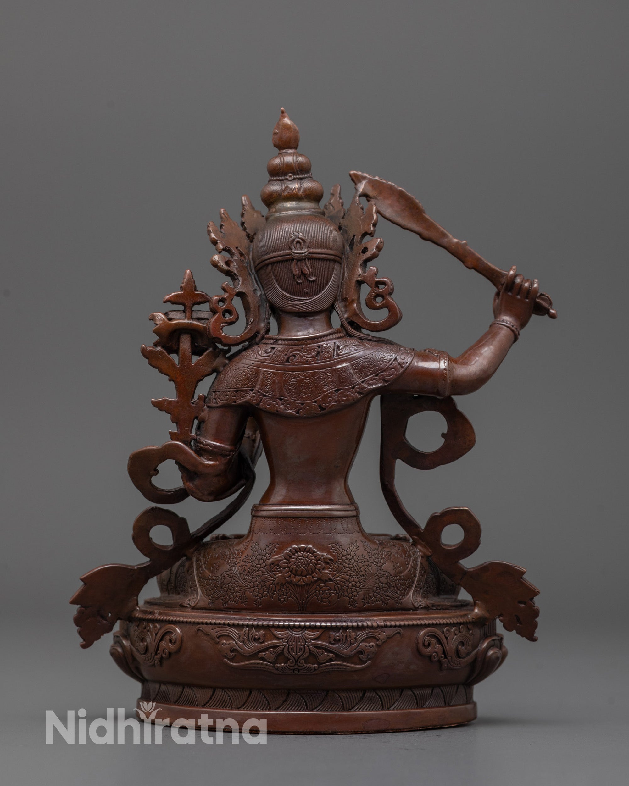 Back view of oxidized Manjushri statue revealing lotus seat and uniform electroplated finish