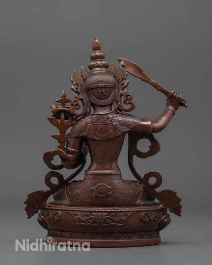 Back view of oxidized Manjushri statue revealing lotus seat and uniform electroplated finish