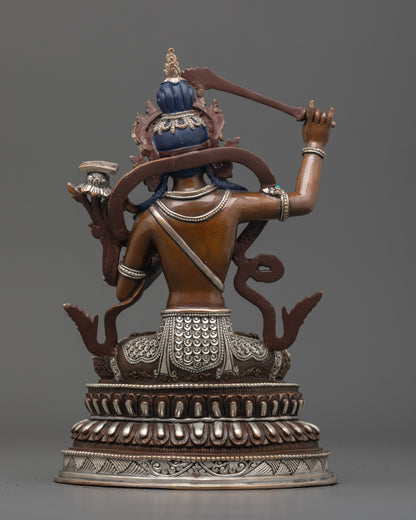 Back view of oxidized Manjushri statue seated on double-layered lotus base with details