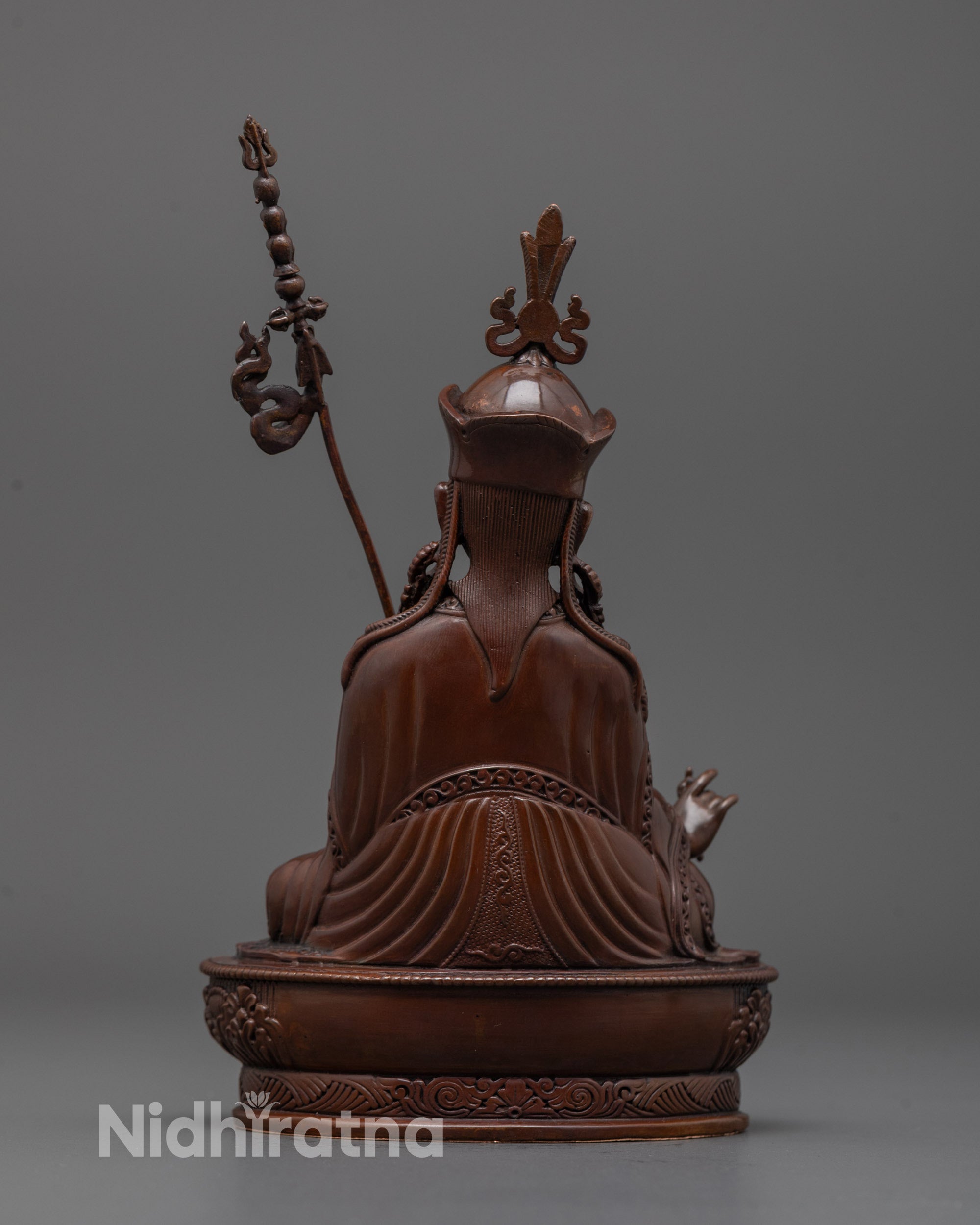 Back view of oxidized Padmasambhava statue highlighting robe patterns