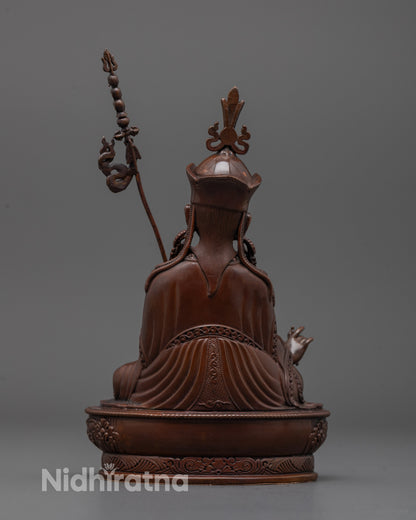 Back view of oxidized Padmasambhava statue highlighting robe patterns