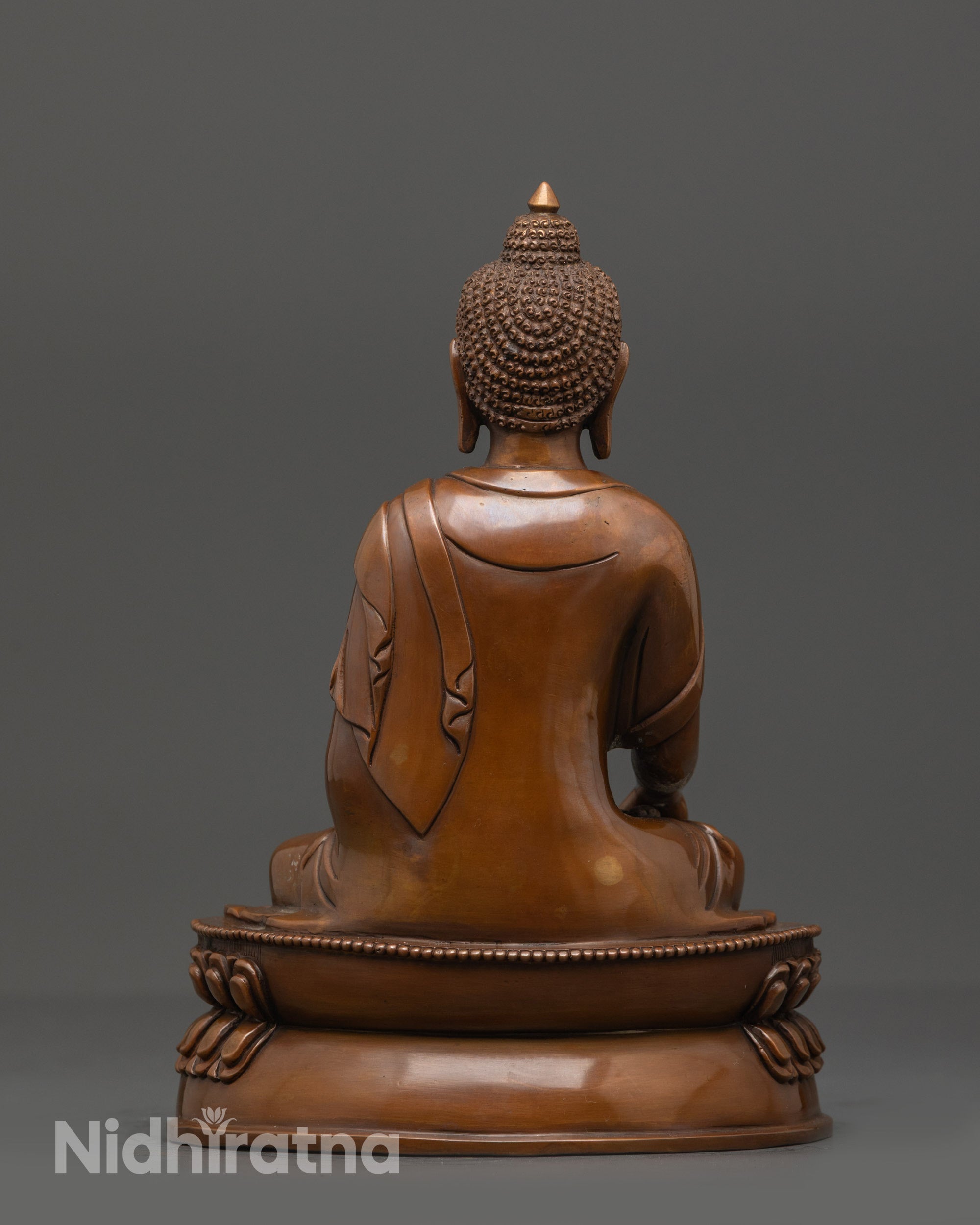Back view of oxidized Shakyamuni Buddha statue highlighting smooth polished copper finish