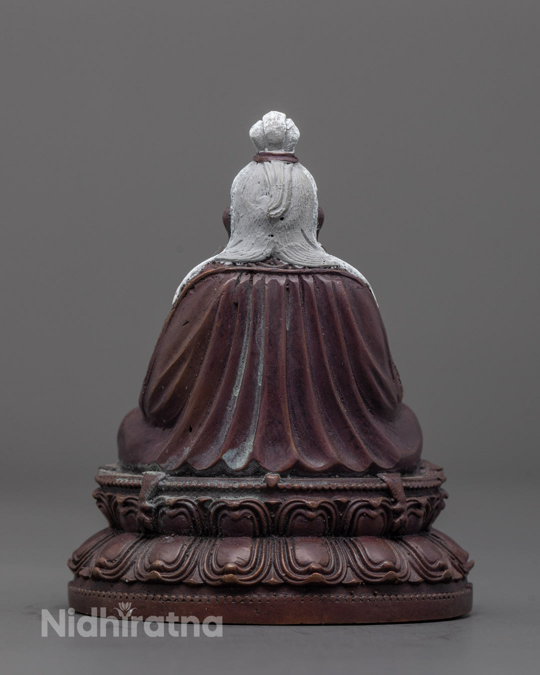 Back view of oxidized Thang Tong Gyalpo statue highlighting lotus throne and craftsmanship