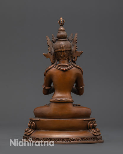 Back view of oxidized Vajradhara statue showing detailed jewelry and earthy hue