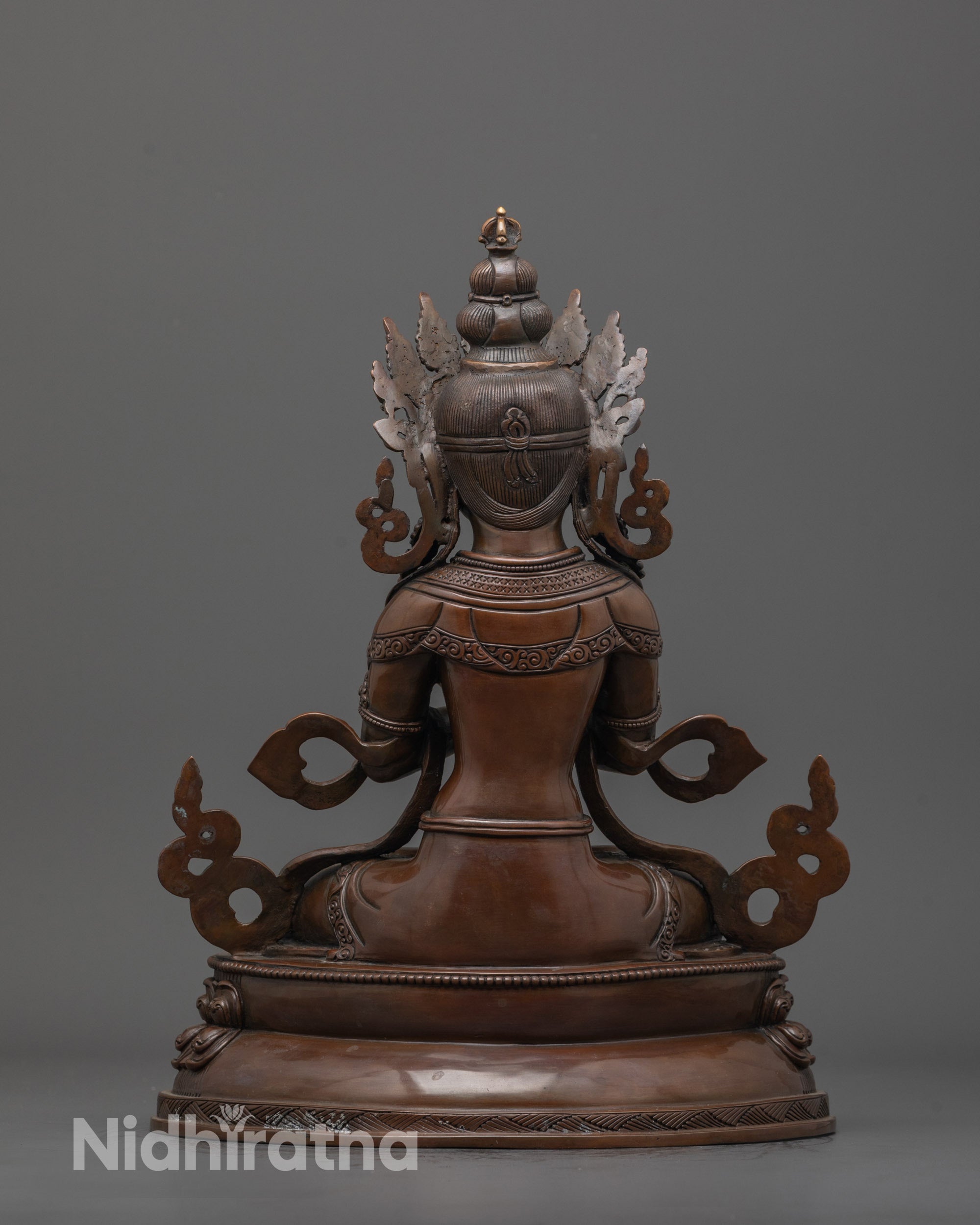 Back view of oxidized Vajradhara statue showing lotus base and fine artisan craftsmanship