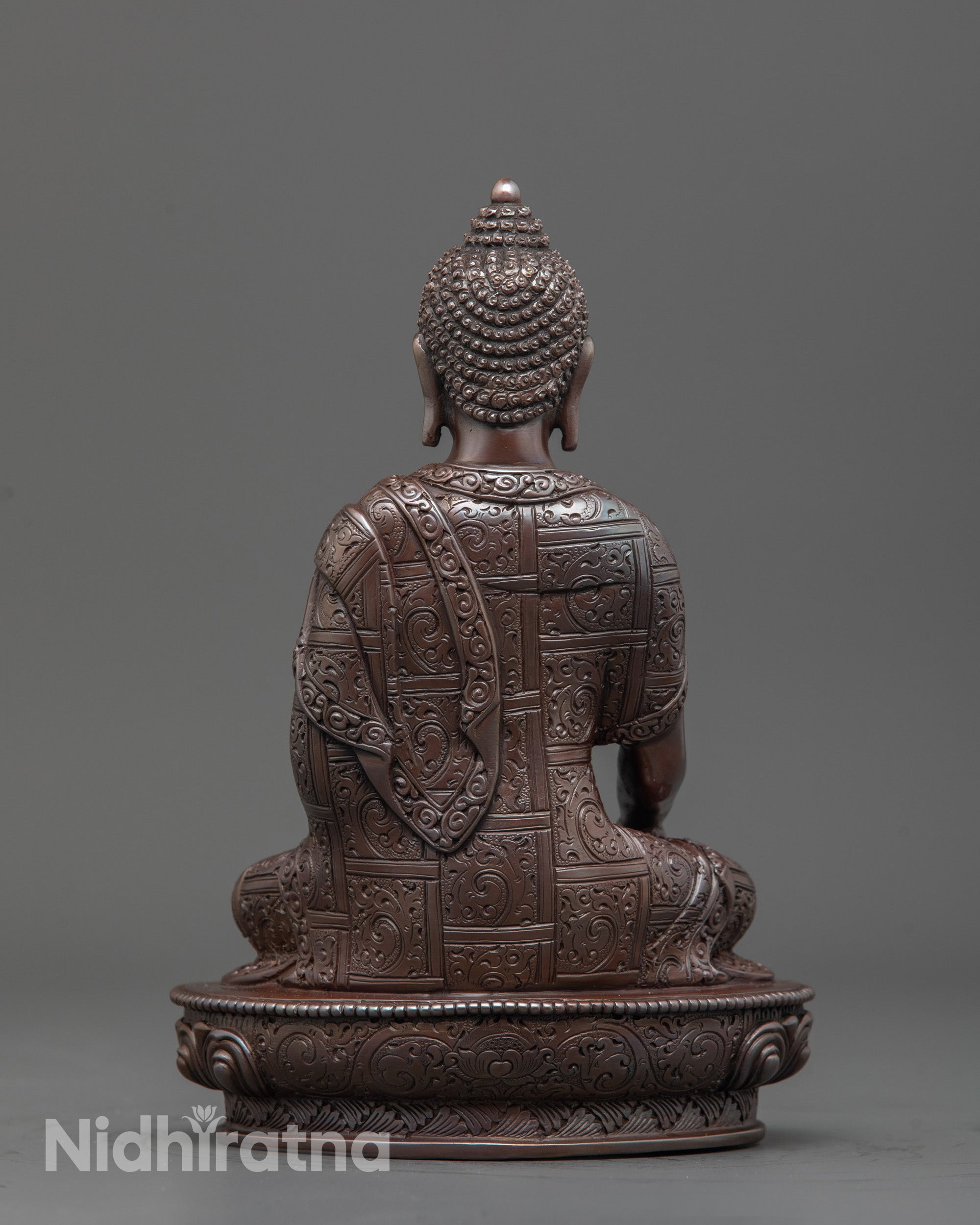 Back view of oxidized copper Gautama Buddha sculpture highlighting detailed craftsmanship