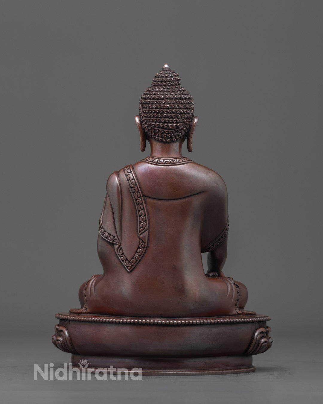 Back view of premium copper oxidized Gautama Buddha statue with intricate details.